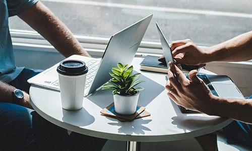 Two people sitting with laptops