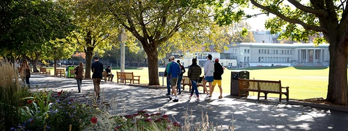 Students waling along the Trinity Cricket pitch path