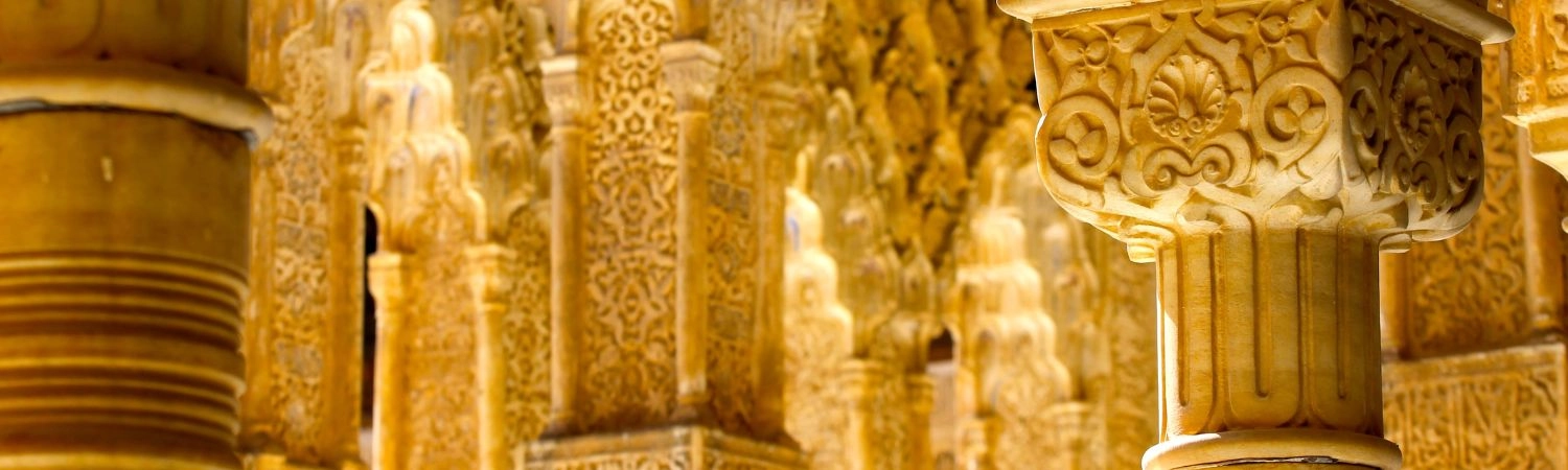 A close-up of ornate stucco work and columns showcasing Islamic craftsmanship