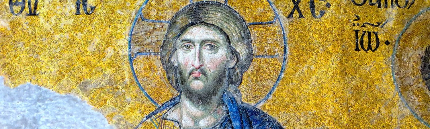 A blue and gold mosaic depicting an image of Christ